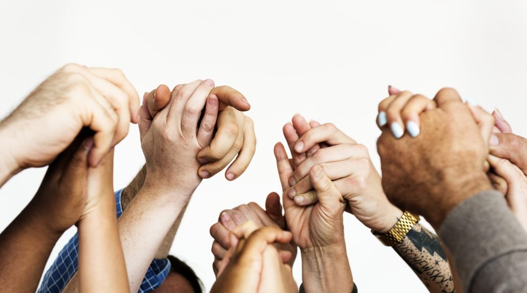 Closeup of diverse people holding hands